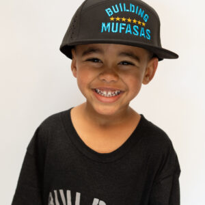 Black Building Mufasas hat with blue embroidered logo worn from front view