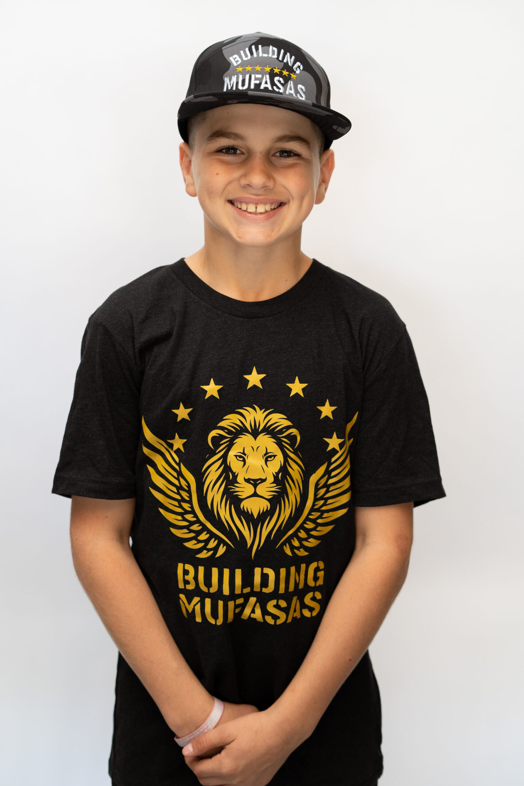 Black Building Mufasas t shirt with gold lion logo and Building Mufasas text on front