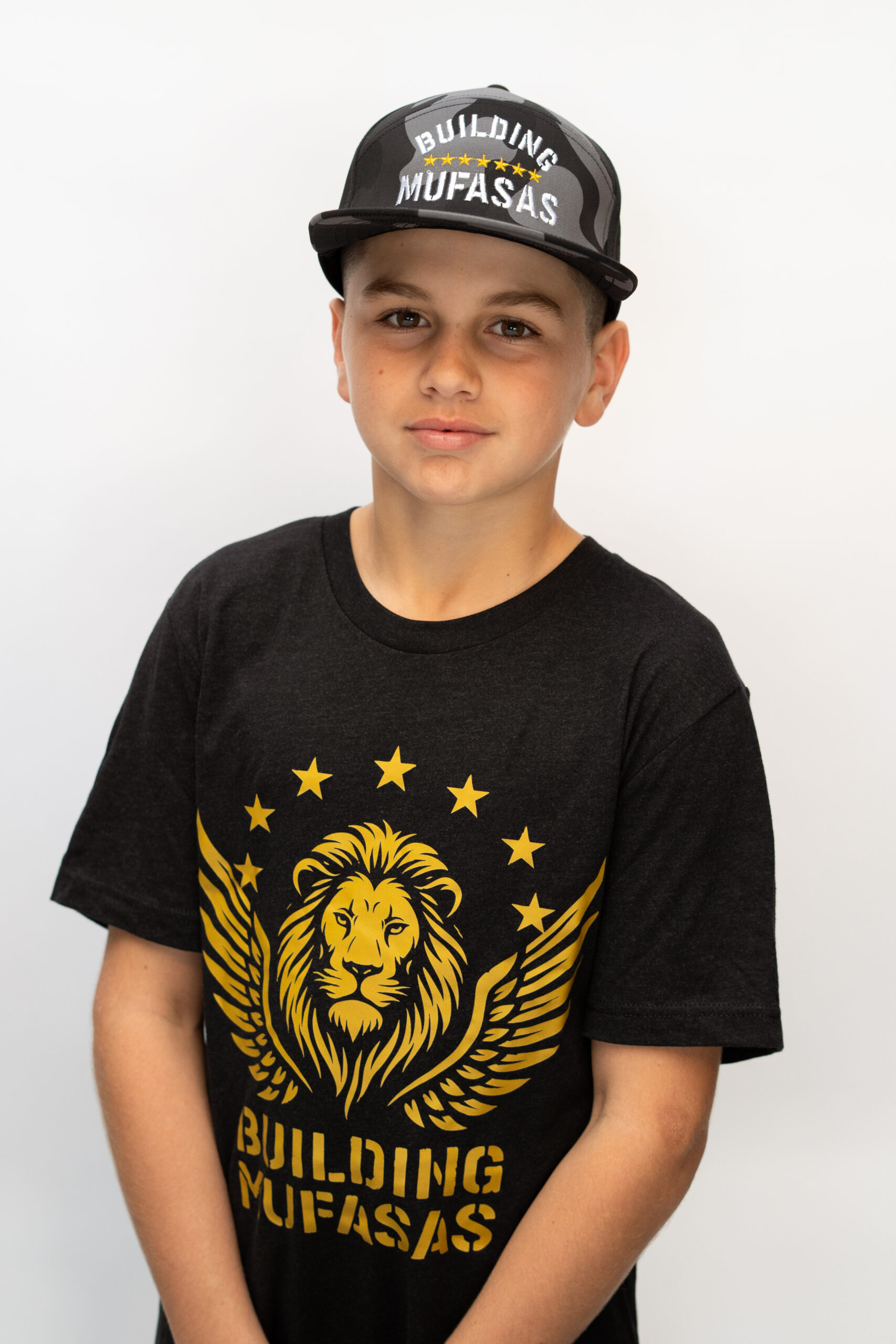 Black Building Mufasas t shirt with gold lion logo and Building Mufasas text on front view